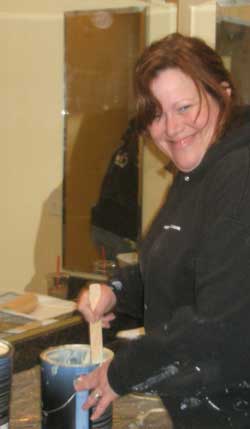 Kris Puleo at work with a can of 'Aura' paint